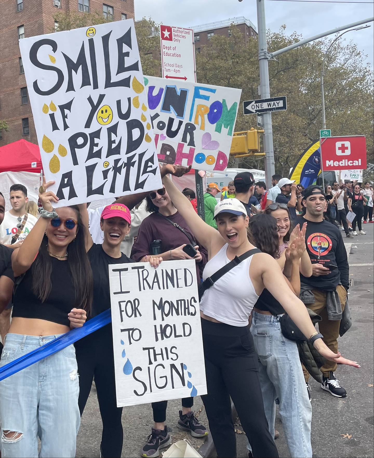 Fans of the New York City Marathon hold signs for some of the 50,000 runners who passed them