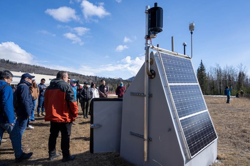 A group from the Seismological Society of America tours a seismic station on the playground of Glacier View School on Tuesday, April 30 in Chickaloon. (Loren Holmes / ADN)