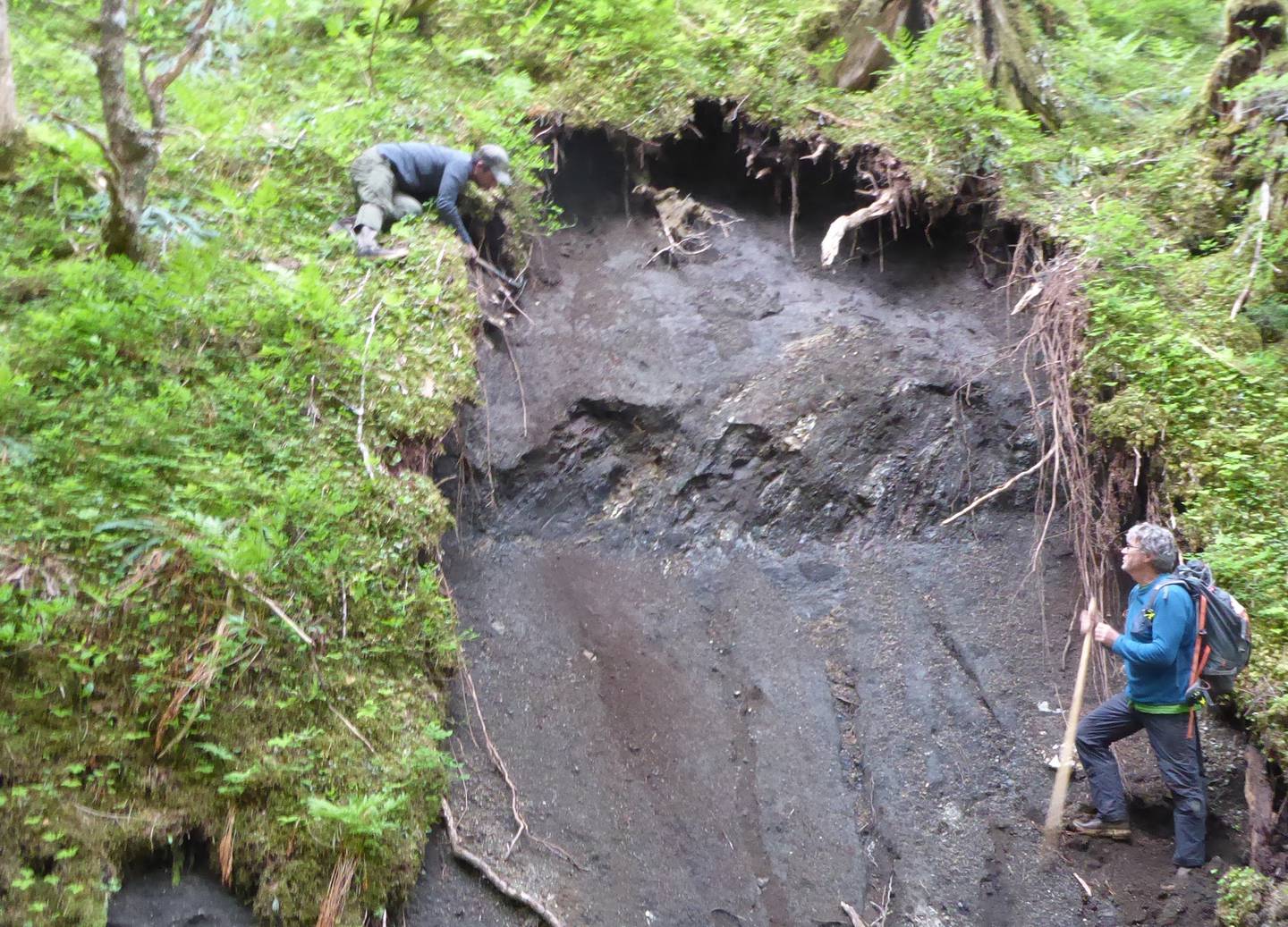 Ben Gaglioti and Dan Mann check an exposed section of ground