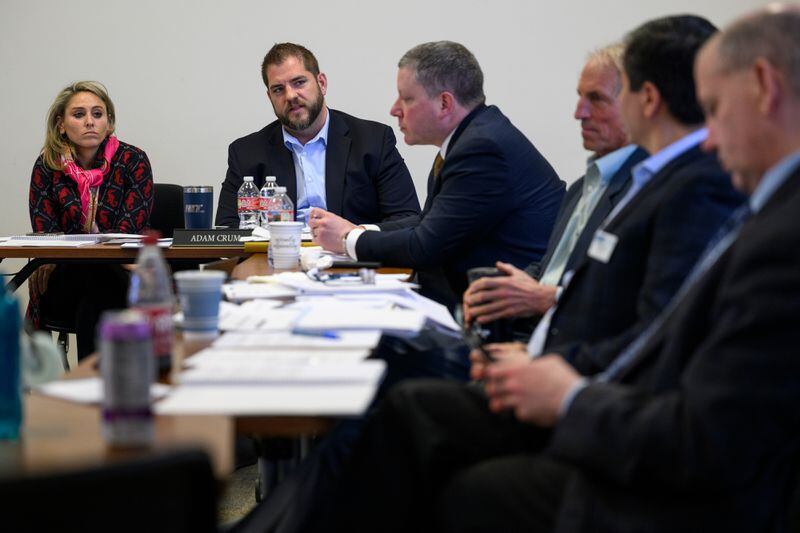 On April 12, 2023, trustees including, from left, Ellie Rubenstein, Adam Crum and Craig Richards, talk during a meeting of the Alaska Permanent Fund Corp. board of trustees in Anchorage. (Marc Lester / ADN)