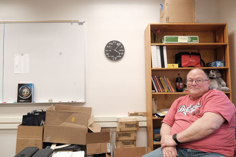 Math teacher Steve Mosley sits in his classroom at Ben Eielson Junior Senior High School on April 22, 2024. He has mostly packed his materials in anticipation of moving to North Pole High School next year. “Very sad to see the school close. It had a really important impact in the community and especially on base kids. They come in and out of here every three years for the most part, so it was a good place for them to gather with their peers the smaller school environment,” he said. (Photo by Claire Stremple/Alaska Beacon)