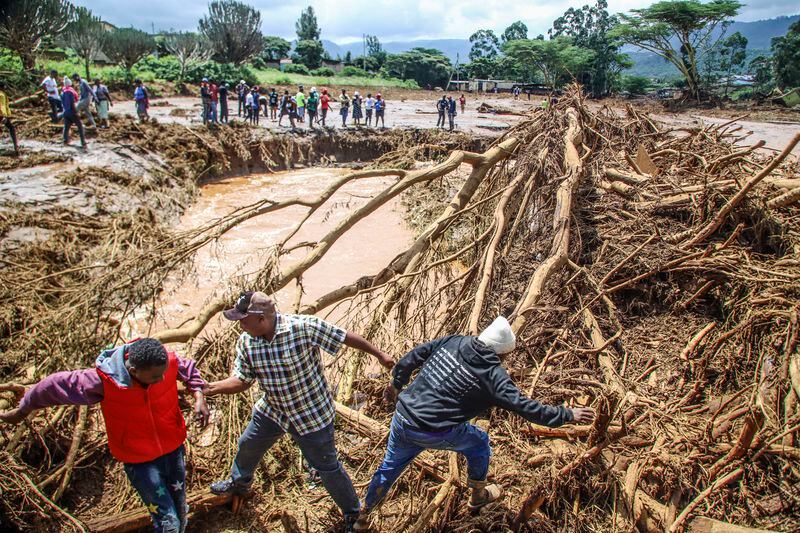 People try to clear a flooded area in Kamuchiri Village Mai Mahiu, Nakuru County, Kenya, Monday, April 29, 2024. (AP Photo/Patrick Ngugi)