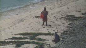 Three men rescued from remote island after writing 'HELP' on the sand