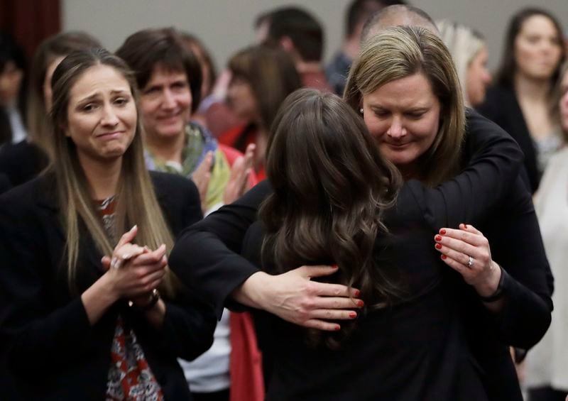 FILE -In this Jan. 24, 2018, file photo, victims react and hug Assistant Attorney General Angela Povilaitis after Larry Nassar was sentenced by Judge Rosemarie Aquilina to 40 to 175 years in prison during a sentencing hearing in Lansing, Mich. (AP Photo/Carlos Osorio, File)