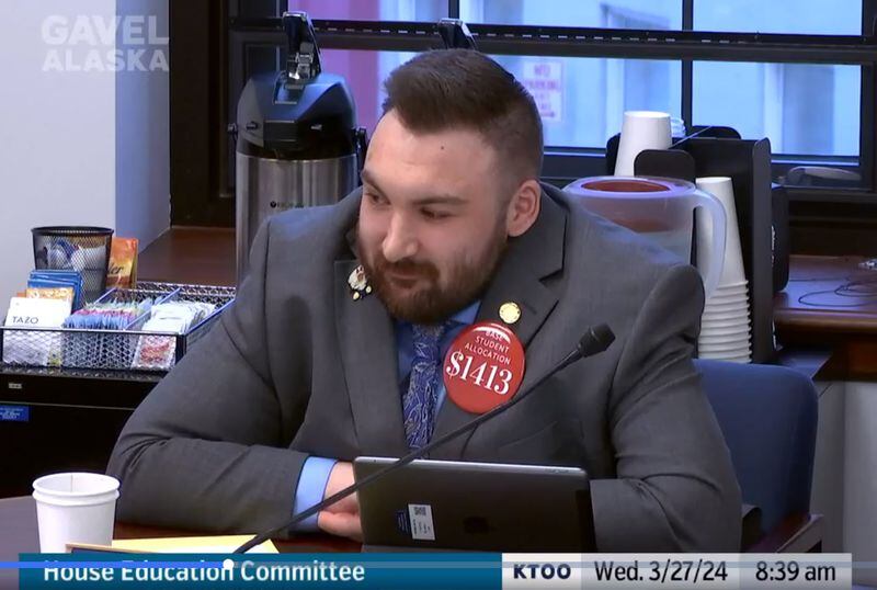 Rep. CJ McCormick, D-Bethel wears a button suggesting a base student allocation boost during a committee meeting Wednesday morning, March 27, 2024. (Screenshot from Gavel Alaska)