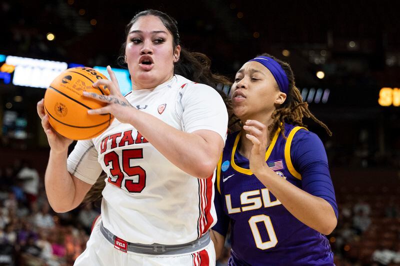 Utah's Alissa Pili (35) fights for control of the basketball with LSU's LaDazhia Williams (0) in the first half of a Sweet 16 college basketball game of the NCAA Tournament in Greenville, S.C., Friday, March 24, 2023. (AP Photo/Mic Smith)