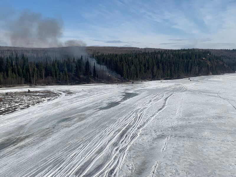 Smoke rises from the crash site of a Douglas DC-4 on Tuesday about 7 miles south of the Fairbanks International Airport on the Tanana River. (Photo provided by Alaska State Troopers)