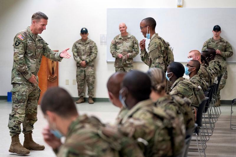 Chief of Staff of the Army Gen. James McConville gestures to a student in the new Army prep course at Fort Jackson, S.C., Aug. 26, 2022. (AP Photo/Sean Rayford, File)