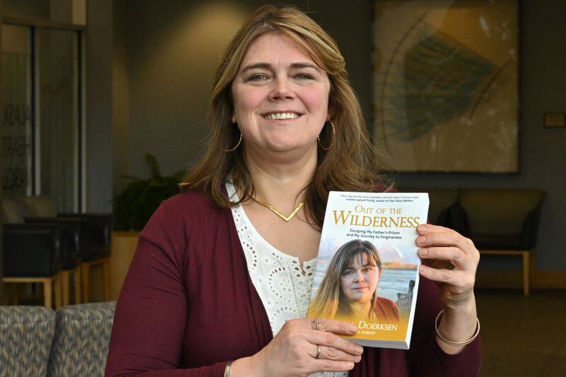 Elishaba Doerksen holds a copy of the book she wrote. (Bill Roth / ADN)