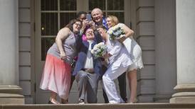 Gay couples wed on historic day as conservatives resist
