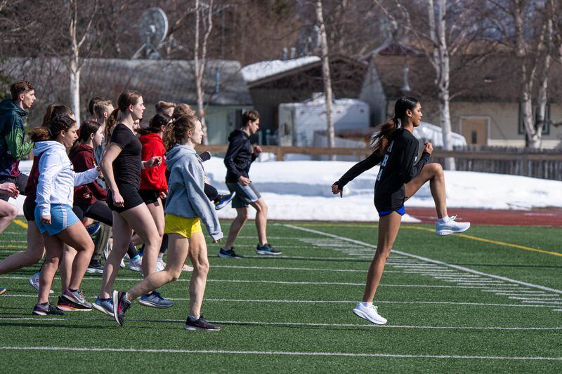 Dimond High freshman athlete Nevaeh Watkins, right, warms up with her teammates on Wednesday, April 11, 2024 in Anchorage. (Loren Holmes / ADN)