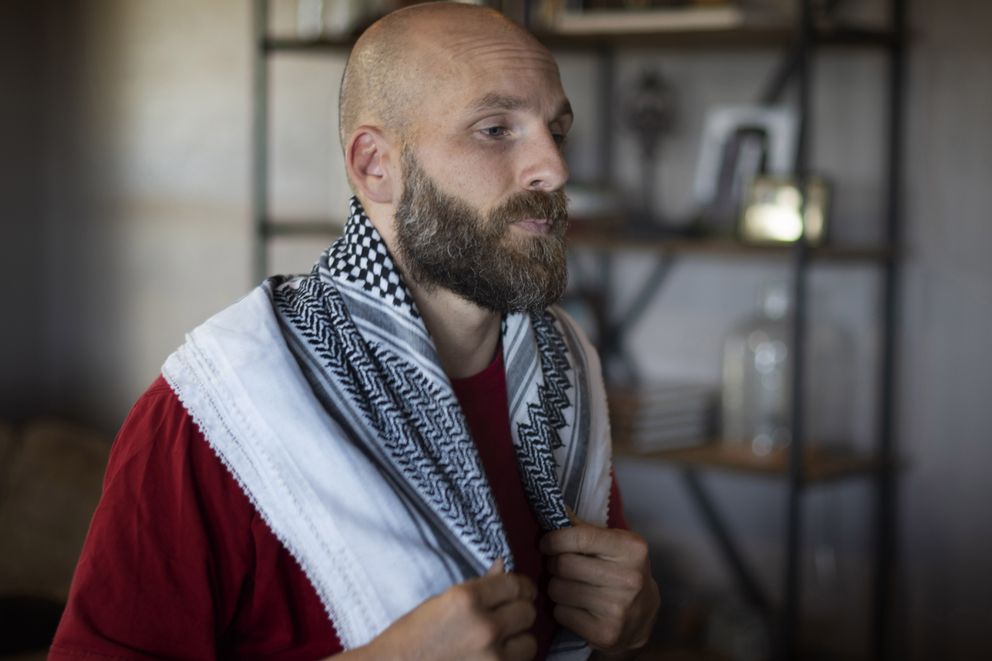 Michael Behenna wears a scarf he brought home from Iraq at his farm near Guthrie, Okla., where he has been living since his parole from military prison. (Photo for The Washington Post by J Pat Carter)