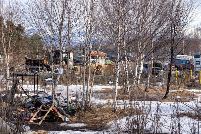 Vehicles and tents fill a parking lot and city-owned vacant lot next to Cuddy Park on Monday, April 22, 2024 in Anchorage. The site is one of the city's most visible homeless camps. (Loren Holmes / ADN)
