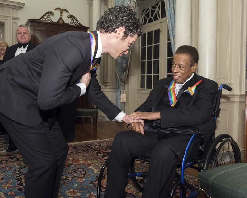 2018 Kennedy Center Honorees Thomas Kail, left, one of the co-creators of "Hamilton," talks with Wayne Shorter, jazz saxophonist and composer, following the Kennedy Center Honors State Department Dinner on Saturday, Dec. 1, 2018, in Washington. (AP Photo/Kevin Wolf)