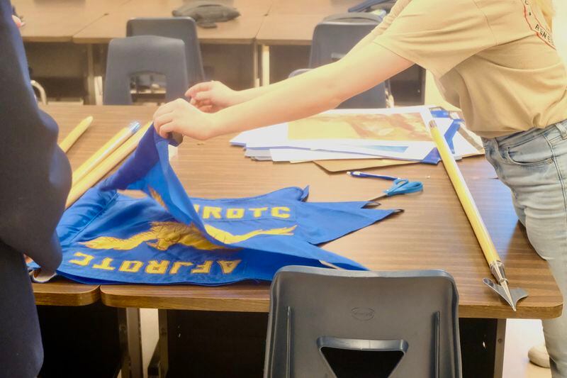 An Air Force JROTC student folds a flag in a Ben Eielson Junior Senior High School classroom on April 22, 2024. (Photo by Claire Stremple/Alaska Beacon)