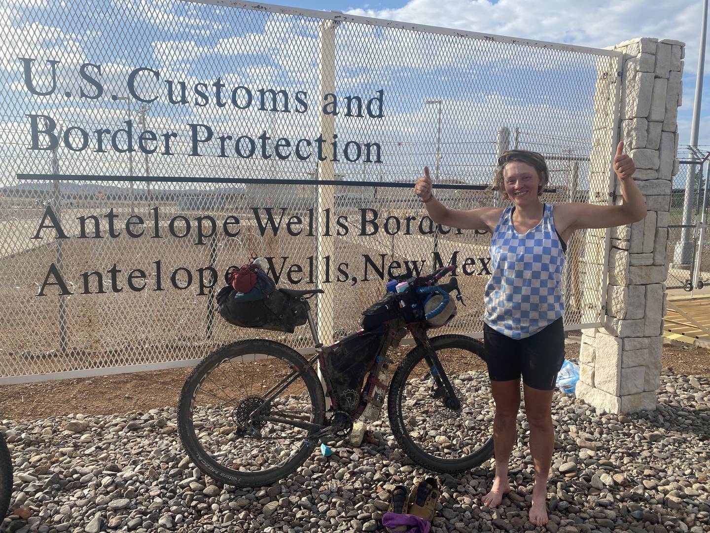 Ana Jager celebrates near the U.S./Mexico border after winning the women's Tour Divide bike race