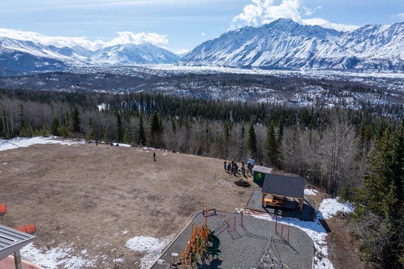 A group from the Seismological Society of America tours a seismic station on the playground of Glacier View School on Tuesday, April 30 in Chickaloon.  (Loren Holmes / ADN)