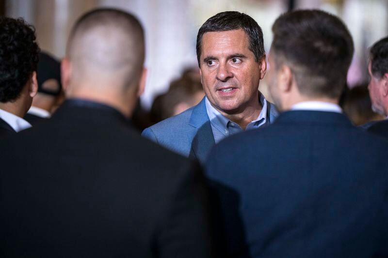 Trump Media chief Devin Nunes, then a House Republican, works the audience before former president Donald Trump announces his reelection bid at Mar-a-Lago in 2022. (Thomas Simonetti for The Washington Post)